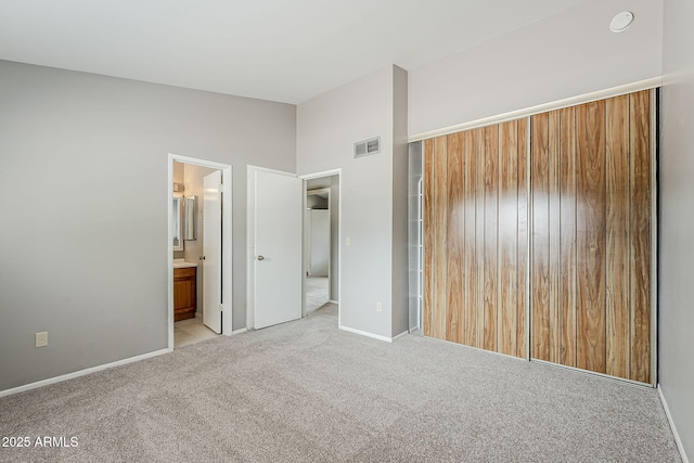 2515 S Maple Ave Unit 103, Tempe, AZ 85282 - unfurnished bedroom featuring carpet flooring, baseboards, vaulted ceiling, and ensuite bath