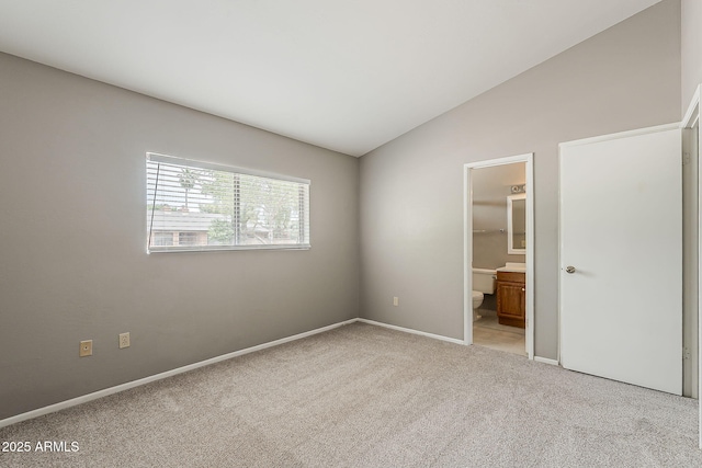 2515 S Maple Ave Unit 103, Tempe, AZ 85282 - unfurnished bedroom with light carpet, lofted ceiling, baseboards, and ensuite bath
