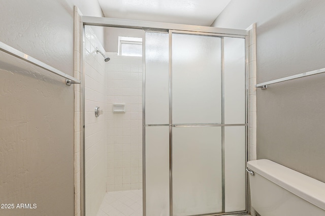 2515 S Maple Ave Unit 103, Tempe, AZ 85282 - bathroom with a shower stall, toilet, and a textured wall