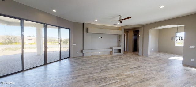 unfurnished living room with ceiling fan, wood finished floors, and recessed lighting