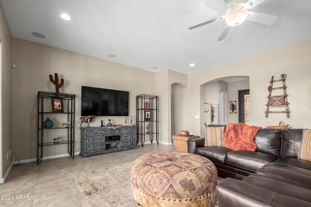 5771 W Cinder Brook Way, Florence, AZ 85132 - living area with arched walkways, baseboards, ceiling fan, light tile patterned floors, and recessed lighting