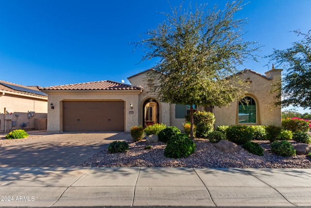 mediterranean / spanish-style home featuring a garage