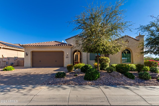 5771 W Cinder Brook Way, Florence, AZ 85132 - mediterranean / spanish-style home featuring a garage, stucco siding, driveway, and a tile roof