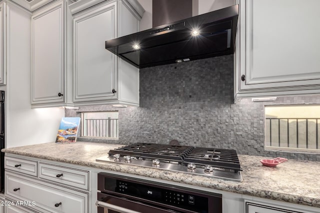 5771 W Cinder Brook Way, Florence, AZ 85132 - kitchen featuring stainless steel appliances, wall chimney range hood, backsplash, light countertops, and white cabinets