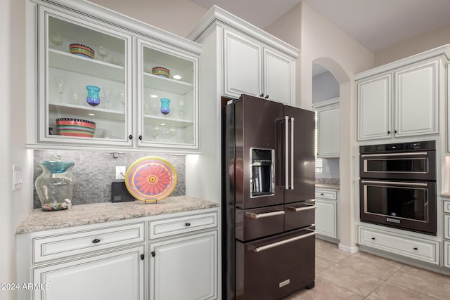 5771 W Cinder Brook Way, Florence, AZ 85132 - kitchen with black appliances, light tile patterned floors, tasteful backsplash, and white cabinetry