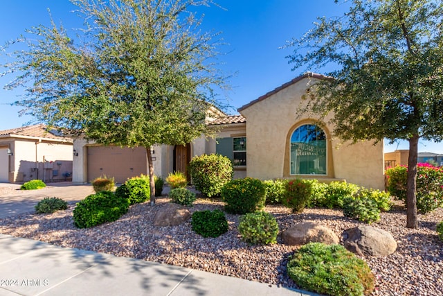 5771 W Cinder Brook Way, Florence, AZ 85132 - mediterranean / spanish home featuring stucco siding, an attached garage, a tile roof, and driveway