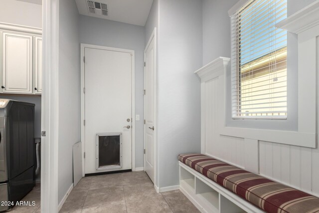 5771 W Cinder Brook Way, Florence, AZ 85132 - mudroom featuring washer / clothes dryer, baseboards, and light tile patterned floors