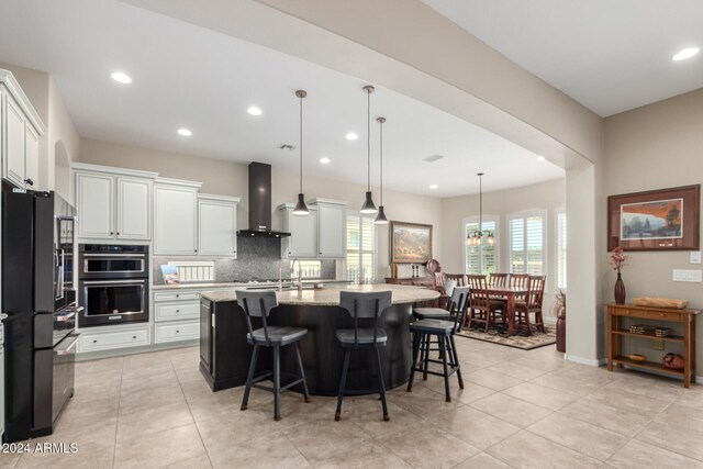 5771 W Cinder Brook Way, Florence, AZ 85132 - kitchen with black refrigerator, wall chimney exhaust hood, white cabinets, double oven, and backsplash