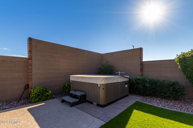 5771 W Cinder Brook Way, Florence, AZ 85132 - view of patio with a hot tub and a fenced backyard