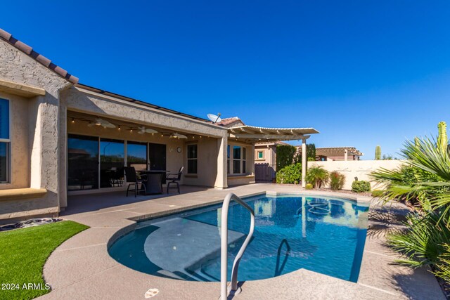 5771 W Cinder Brook Way, Florence, AZ 85132 - view of swimming pool with ceiling fan, fence, a patio, and a pergola