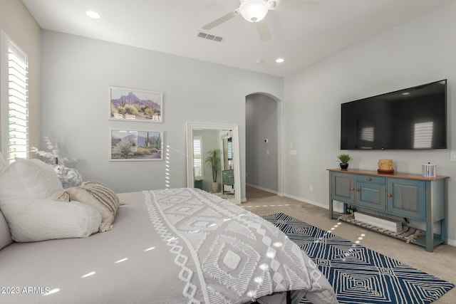 5771 W Cinder Brook Way, Florence, AZ 85132 - bedroom with arched walkways, light carpet, recessed lighting, a ceiling fan, and baseboards