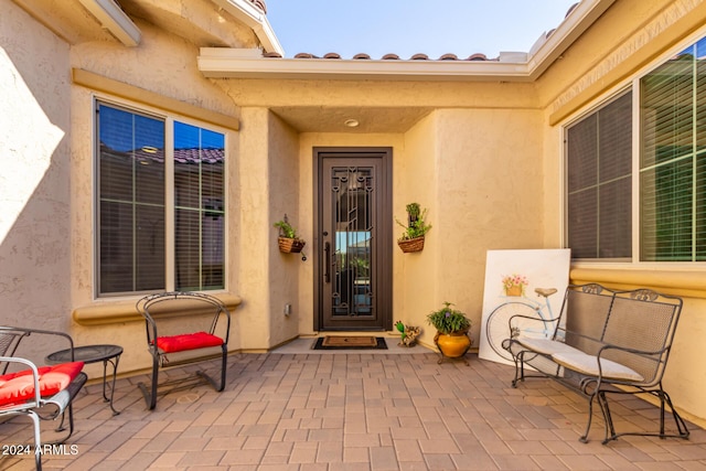 5771 W Cinder Brook Way, Florence, AZ 85132 - doorway to property featuring a patio area and stucco siding