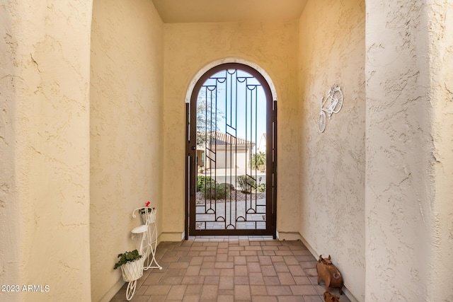 5771 W Cinder Brook Way, Florence, AZ 85132 - view of exterior entry featuring a gate and stucco siding