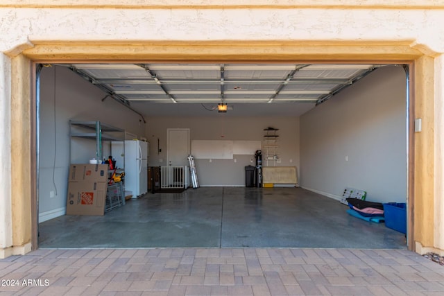 5771 W Cinder Brook Way, Florence, AZ 85132 - garage featuring freestanding refrigerator and baseboards
