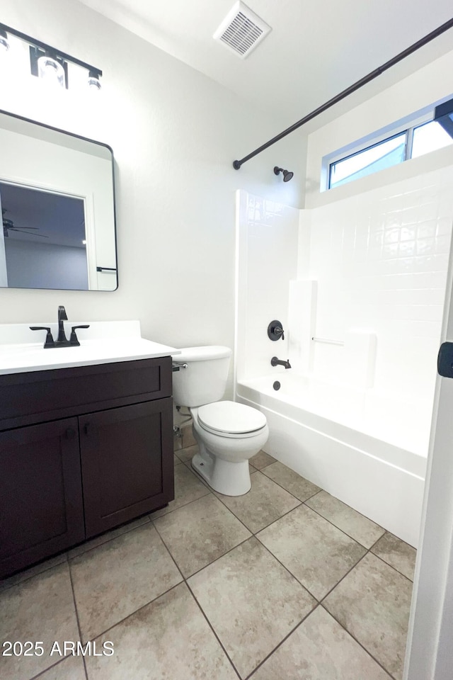 bathroom featuring toilet, vanity, shower / bathtub combination, and tile patterned flooring