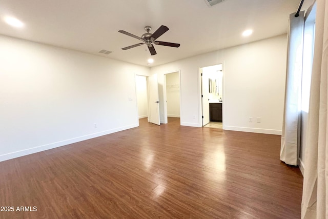 unfurnished bedroom with baseboards, dark wood-style flooring, recessed lighting, a spacious closet, and ceiling fan