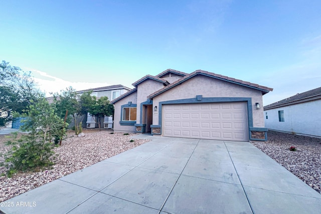ranch-style house featuring a garage, driveway, and stucco siding