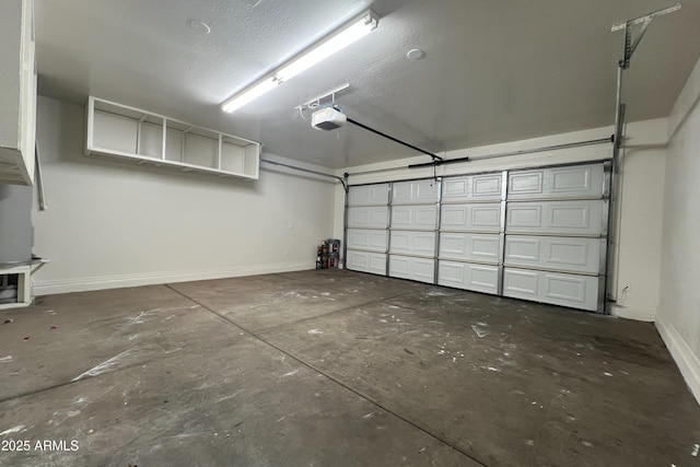 garage with a garage door opener and baseboards