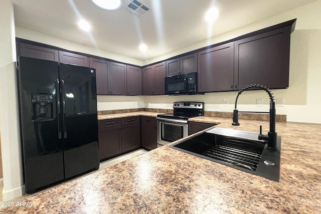 kitchen featuring black appliances, a sink, light countertops, and dark brown cabinets