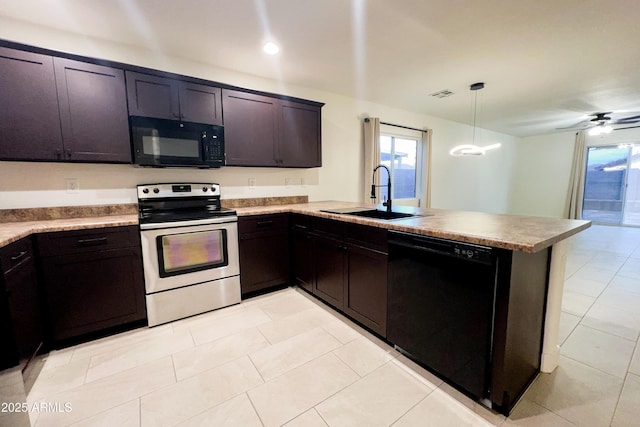 kitchen featuring black appliances, a sink, a peninsula, light tile patterned floors, and light countertops