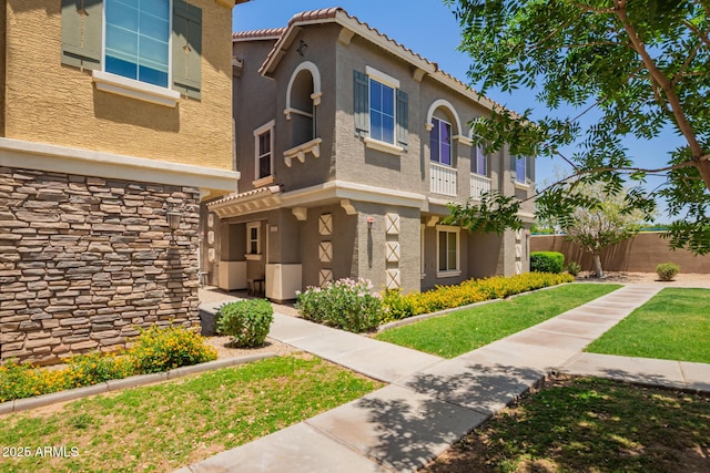 9233 E Neville Ave Unit 1127, Mesa, AZ 85209 - view of front of home featuring stucco siding, stone siding, and a tile roof