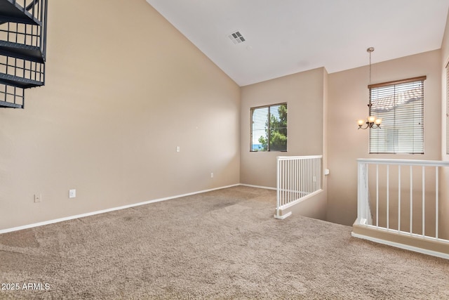 9233 E Neville Ave Unit 1127, Mesa, AZ 85209 - empty room featuring carpet, vaulted ceiling, healthy amount of natural light, and a chandelier