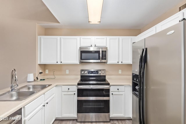 9233 E Neville Ave Unit 1127, Mesa, AZ 85209 - kitchen with appliances with stainless steel finishes, white cabinets, and light countertops