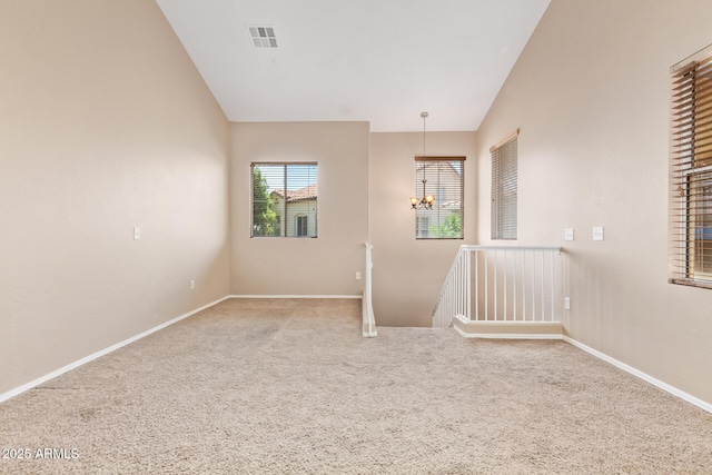 9233 E Neville Ave Unit 1127, Mesa, AZ 85209 - carpeted empty room featuring a chandelier and vaulted ceiling