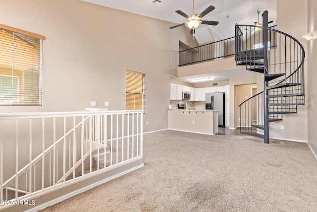 9233 E Neville Ave Unit 1127, Mesa, AZ 85209 - unfurnished living room featuring carpet floors, a ceiling fan, and a high ceiling