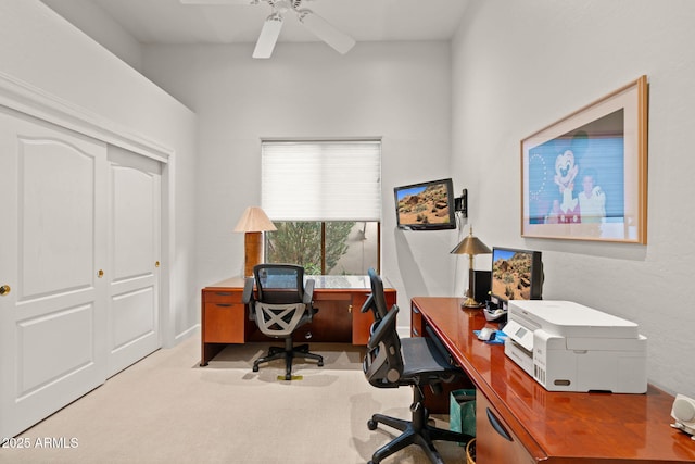 carpeted home office featuring ceiling fan