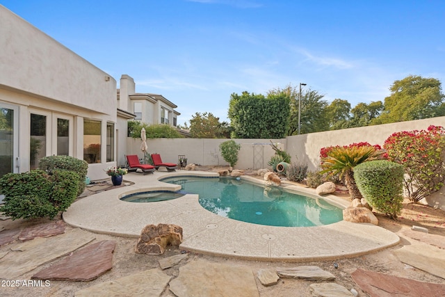 view of pool with an in ground hot tub