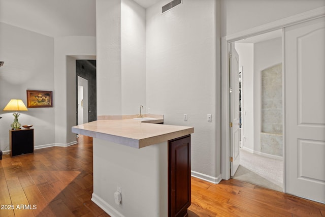 kitchen with a breakfast bar and wood-type flooring