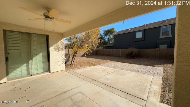 view of patio with a fenced backyard and a ceiling fan