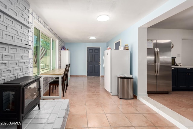 1308 N 66th St, Scottsdale, AZ 85257 - kitchen with freestanding refrigerator, light tile patterned floors, and light countertops