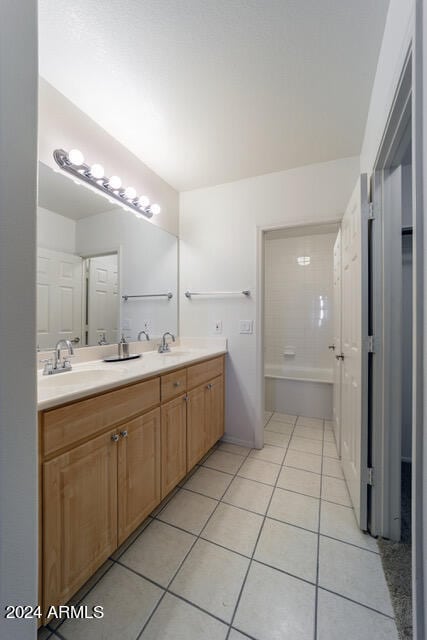 bathroom featuring tile patterned flooring and vanity