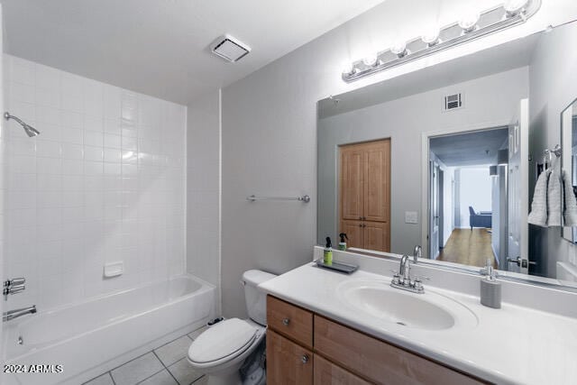 full bathroom with tile patterned flooring, shower / bath combination, vanity, and toilet