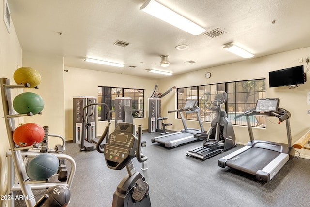 exercise room featuring a textured ceiling