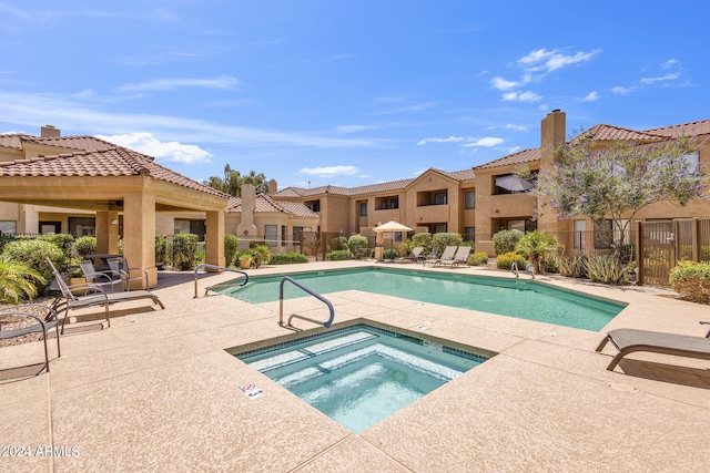 view of pool featuring a community hot tub and a patio area