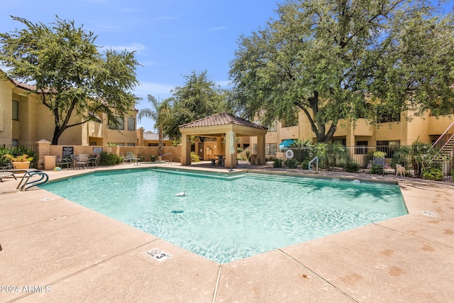 view of swimming pool with a gazebo and a patio area