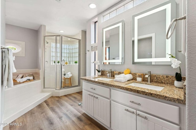 13227 N Mimosa Dr Unit 101, Fountain Hills, AZ 85268 - bathroom featuring a shower stall, double vanity, a bath, wood finished floors, and recessed lighting