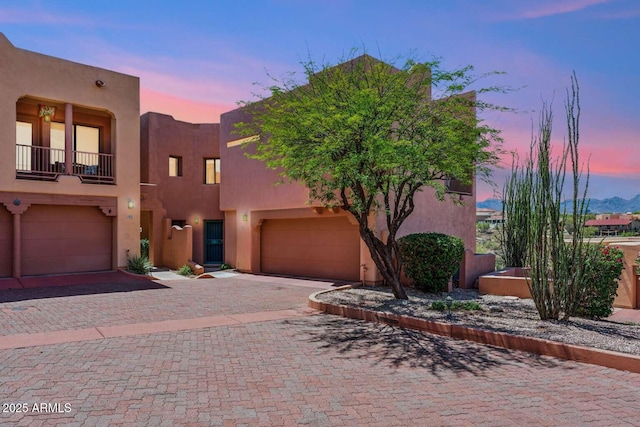 13227 N Mimosa Dr Unit 101, Fountain Hills, AZ 85268 - pueblo revival-style home with stucco siding, a garage, and decorative driveway