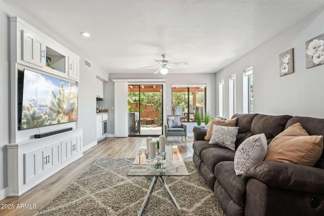 13227 N Mimosa Dr Unit 101, Fountain Hills, AZ 85268 - living room with plenty of natural light, light wood finished floors, ceiling fan, and recessed lighting