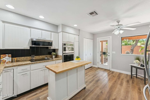 13227 N Mimosa Dr Unit 101, Fountain Hills, AZ 85268 - kitchen featuring butcher block counters, appliances with stainless steel finishes, backsplash, white cabinets, and recessed lighting