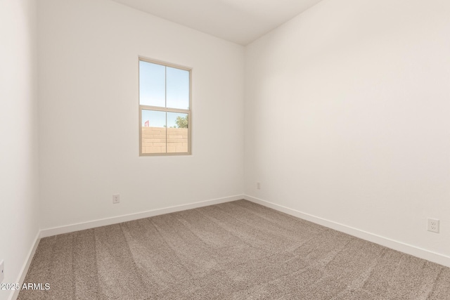 empty room with baseboards and carpet floors