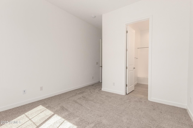 unfurnished bedroom featuring baseboards and light colored carpet