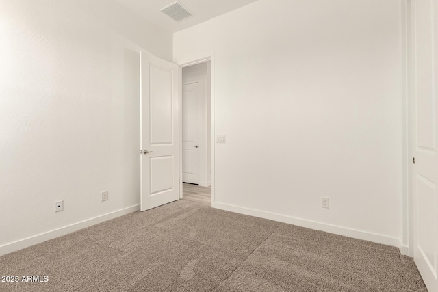 unfurnished bedroom featuring baseboards, visible vents, and light colored carpet