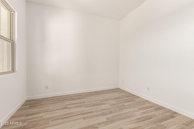 unfurnished room featuring light wood-style flooring and baseboards