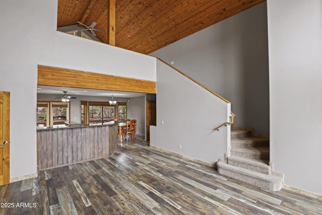 unfurnished living room with wooden ceiling, stairway, wood finished floors, and high vaulted ceiling