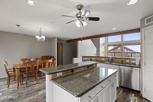 kitchen with a kitchen island, dark wood-type flooring, ceiling fan with notable chandelier, stainless steel dishwasher, and a sink