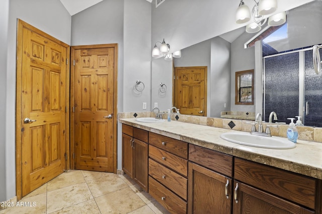 full bath with a sink, lofted ceiling, double vanity, and a shower stall